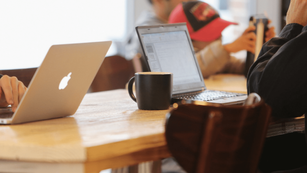 Image showing two laptop users in a coffee shop.